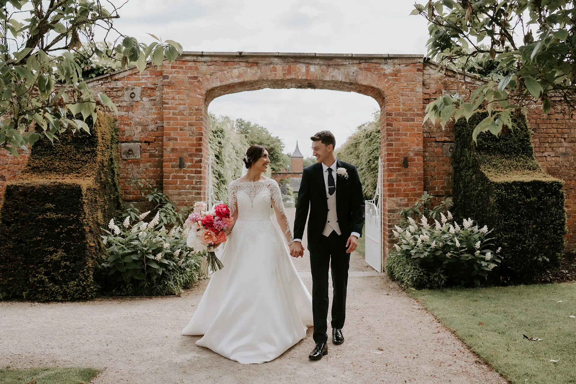 bride and groom in the walled gardens at combermere abbey