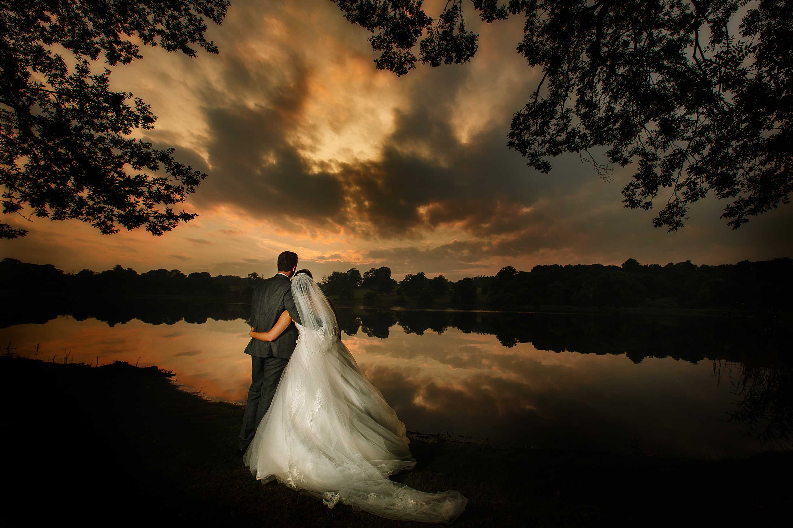 Golden hour wedding photograph at Combermere Abbey by the lakeside