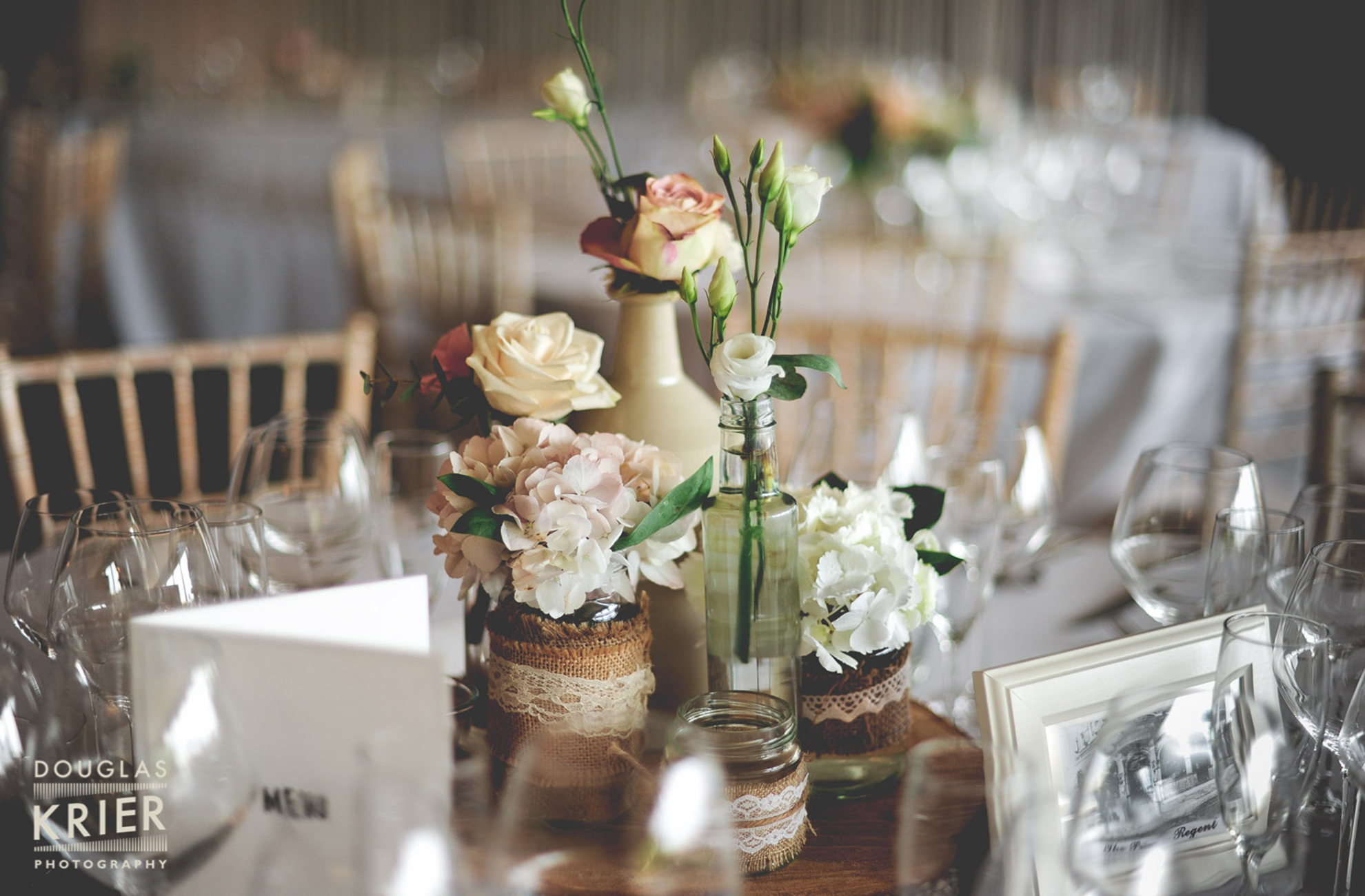 Rustic wedding table centrepieces with hessian and flowers at a Combermere Abbey wedding