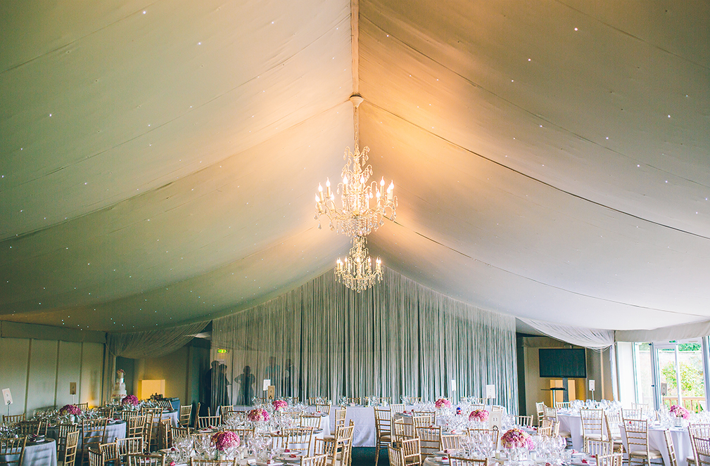 The Pavilion is decorated beautifully with pink flowers and chandeliers hung from the ceiling – wedding ideas