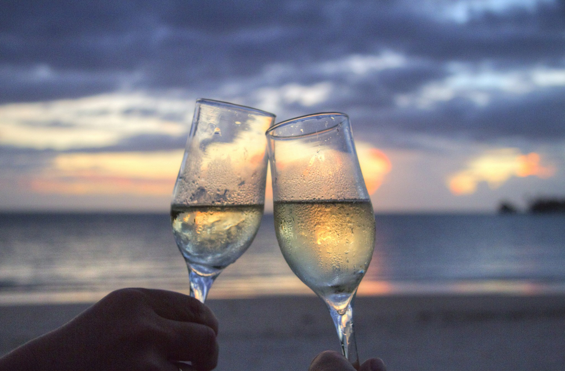 Enjoying a glass of fizz on the beach after the proposal