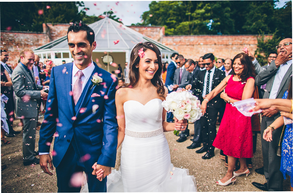 Hayley and Umesh leave the wedding ceremony inside the Glasshouse as guests throw wedding confetti