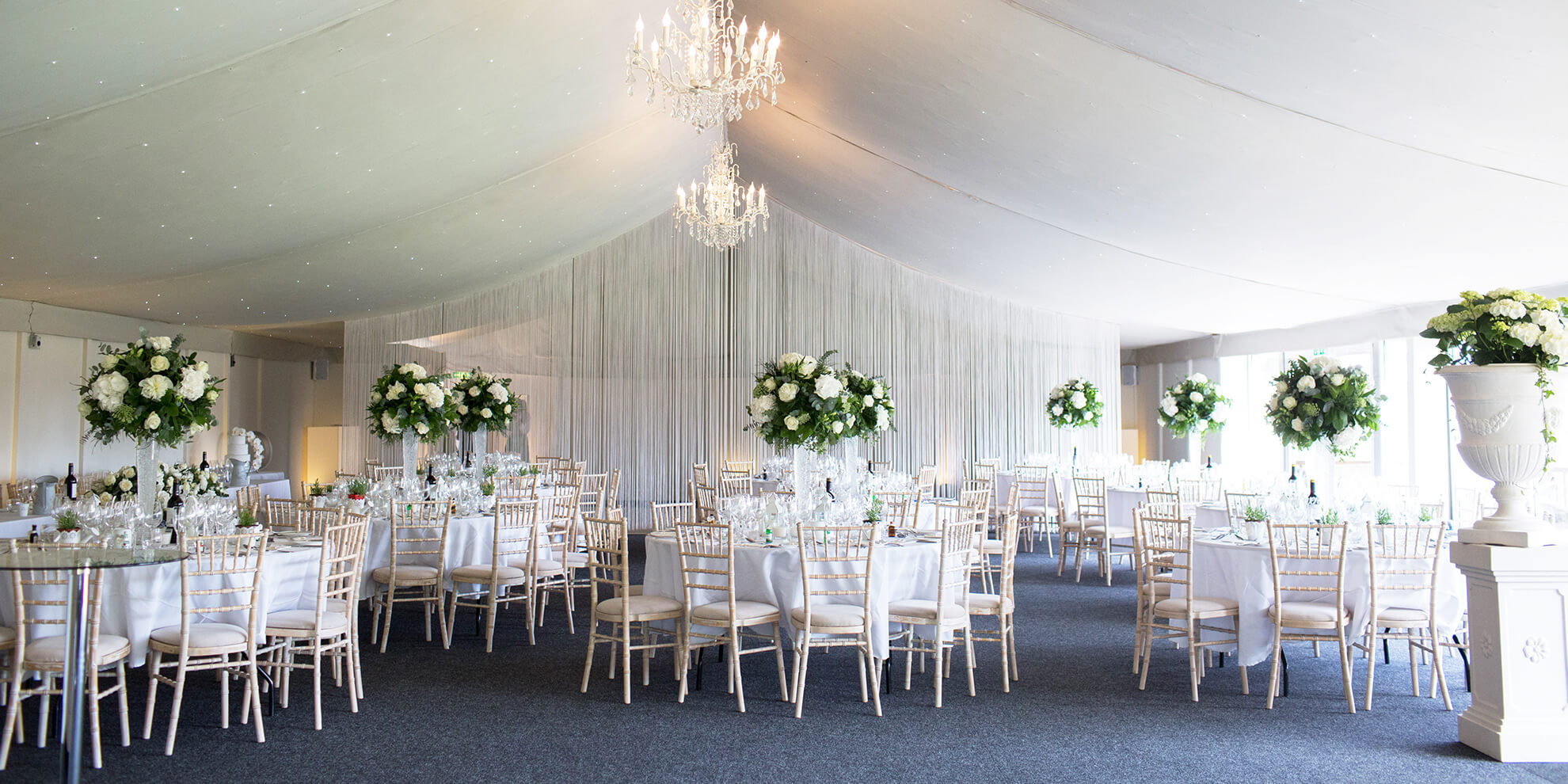 The Pavillion at Combermere Abbey is set up for a stunning white and greenery filled wedding reception