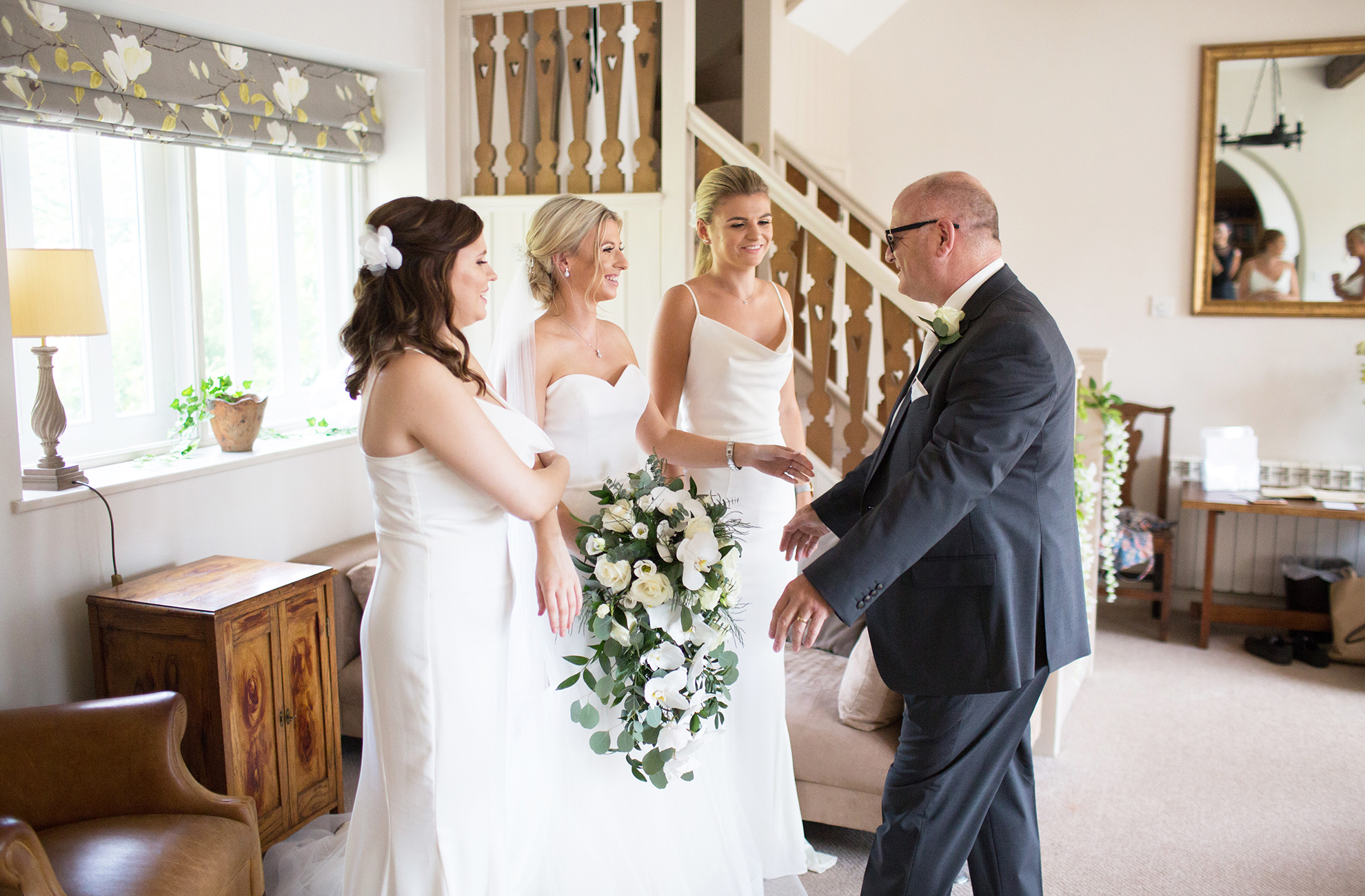 The father of the bride see’s his daughter for the first time on her wedding day at Combermere Abbey in Cheshire