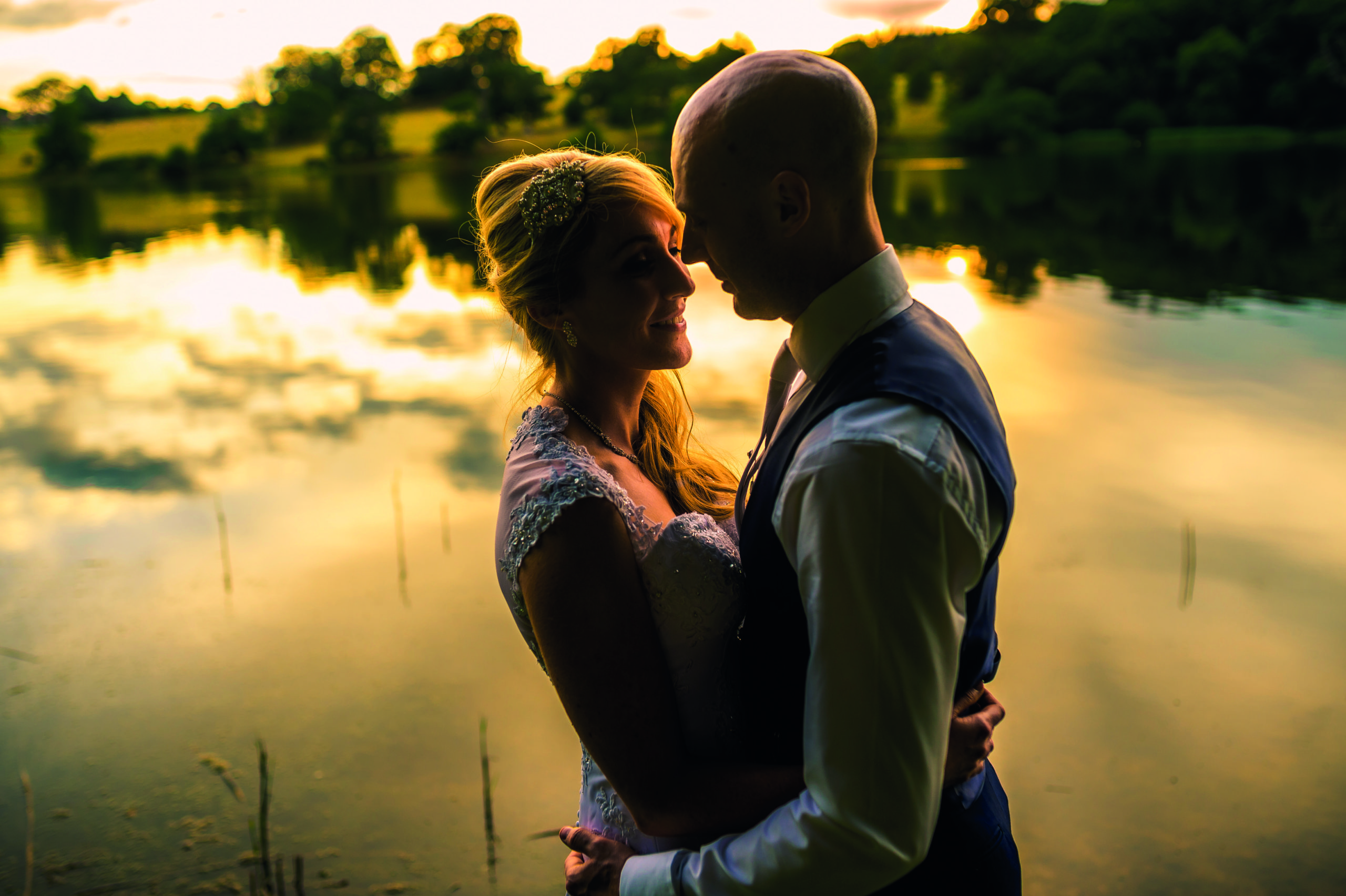 Golden hour wedding photography by the lake at Combermere Abbey